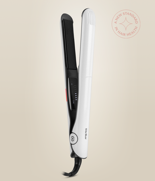 Pearl White Omnia Styler Classic upright and open, with its black plate and temperature controls visible.