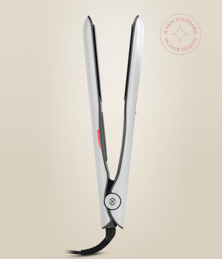 Side view of the Pearl White Omnia Styler Max standing open, showing its hinge and cord.