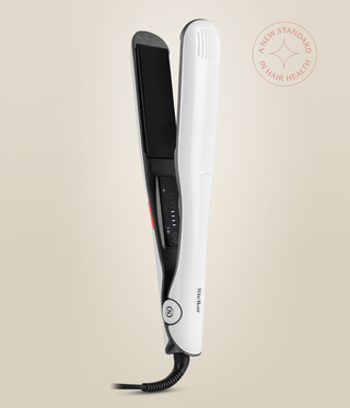 Pearl White Omnia Styler Max upright and open, with its black plate and temperature controls visible.