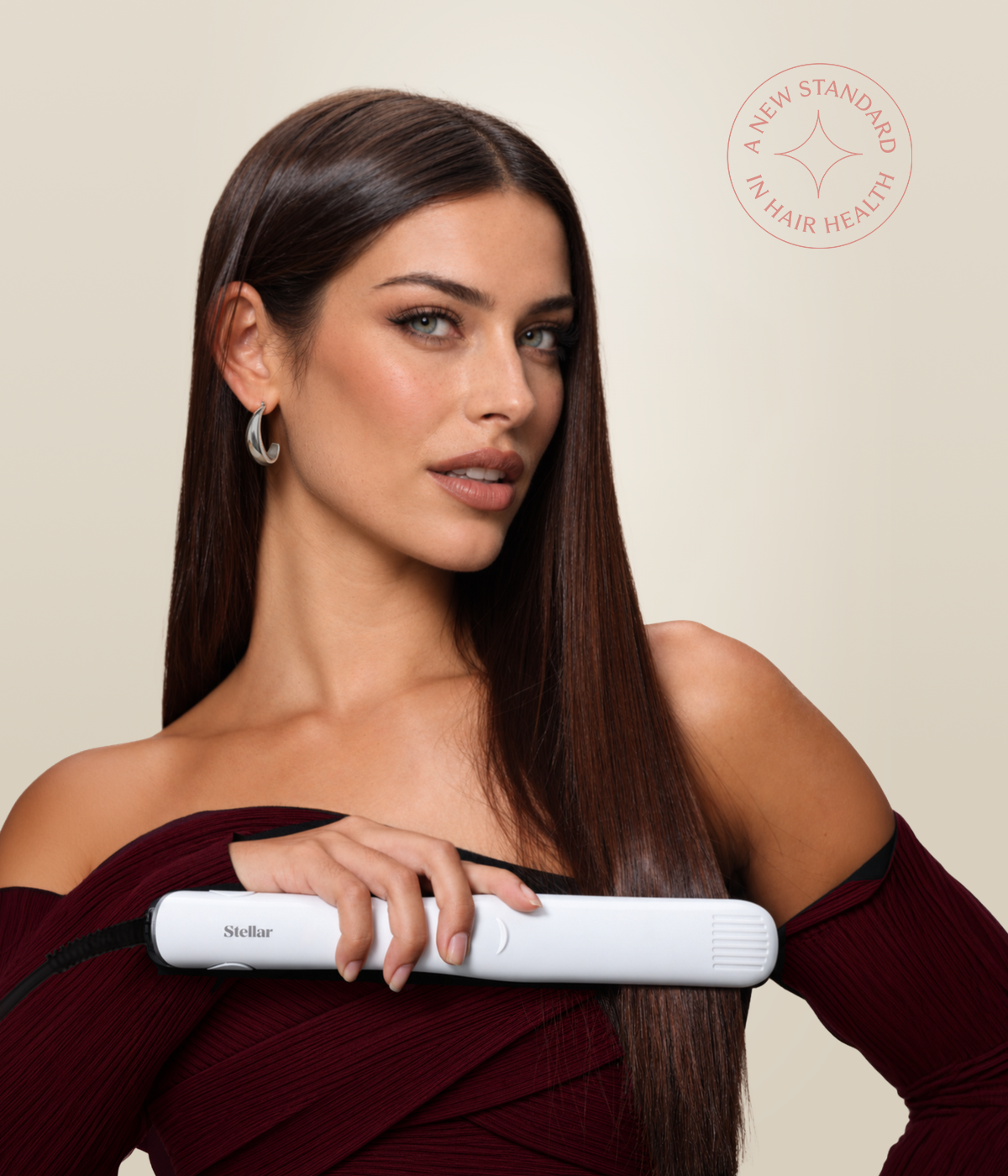 Woman styling her long straight brown hair with a white Stellar styler.