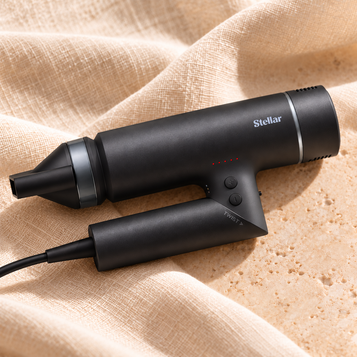 Illustrative black OmniFlex dryer on linen and stone, nozzle pointing left